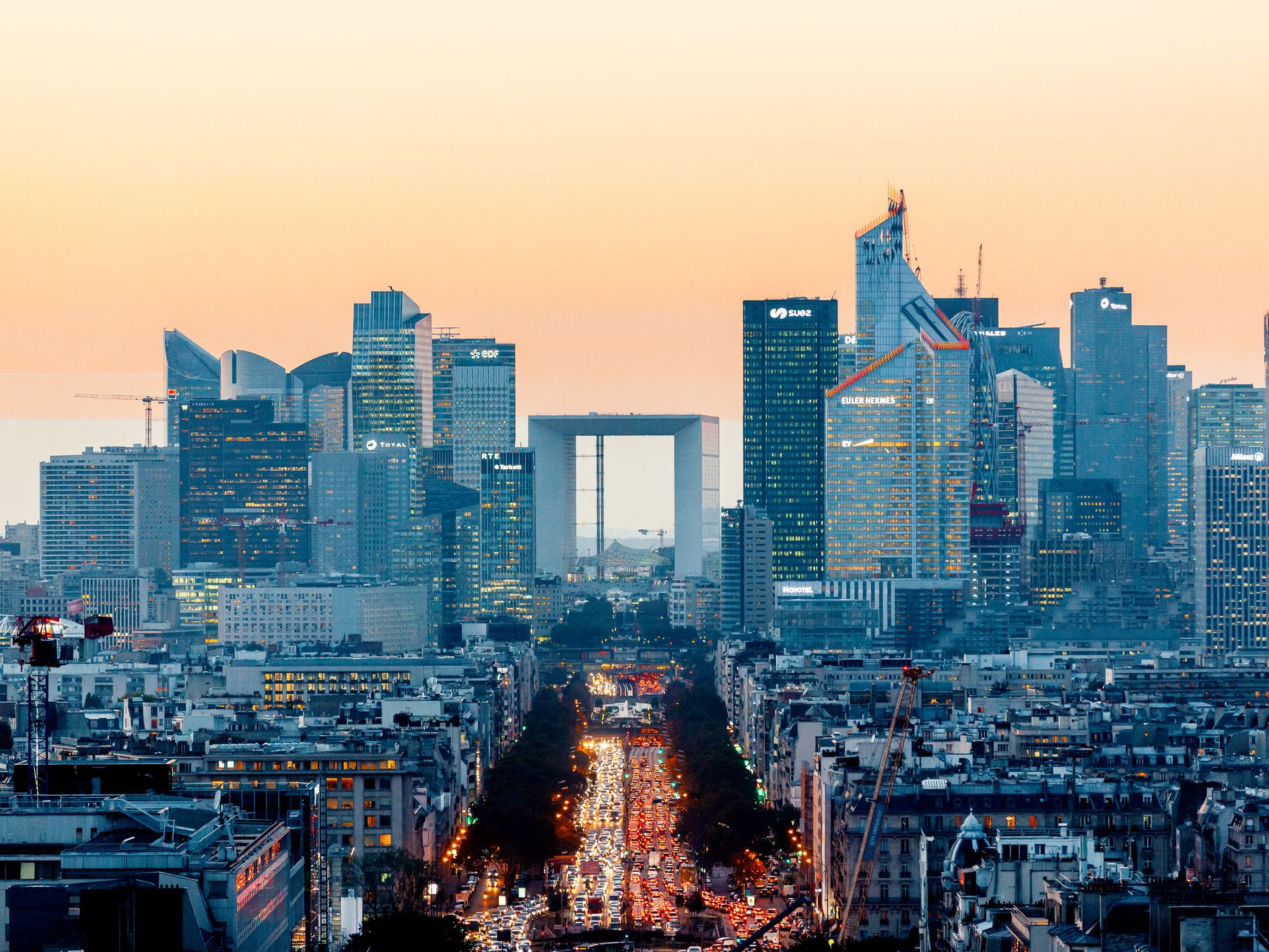 elevated-view-of-illuminated-skyscrapers-at-la-defense-financial-district-and-avenue-des-champs-elysees-at-dusk--paris--france-1095523752-3cb2b3881abc422ca187f42e70f55435